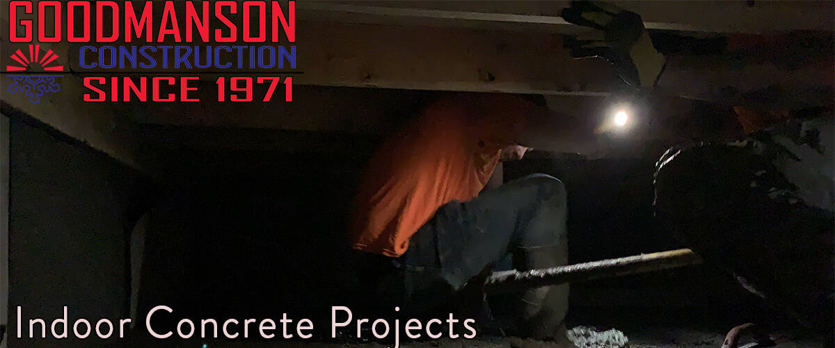 Goodmanson Construction Indoor Commercial Concrete Projects worker under a deck leveling concrete